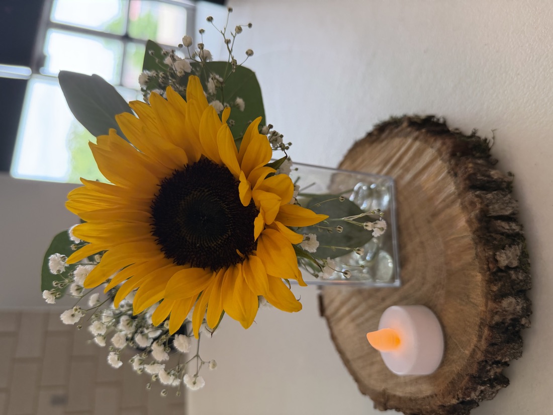 Sunflower centerpiece on a wood slab
